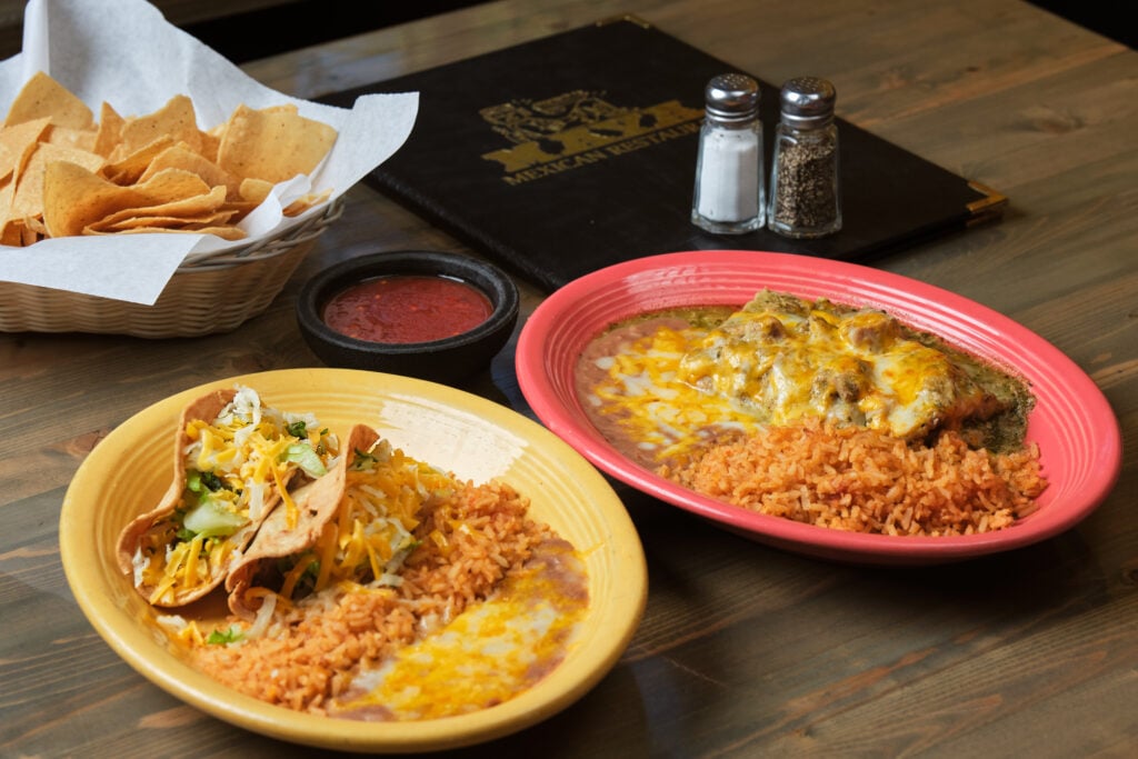 Plated tacos, enchiladas, beans and rice with a bowl of chips and salsa at Maya Mexican Restaurant in Santa Maria Valley